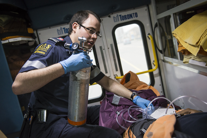 Paramedic administers oxygen