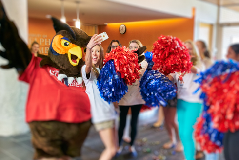 Photo of Swoop and a female student posing for a selfie.