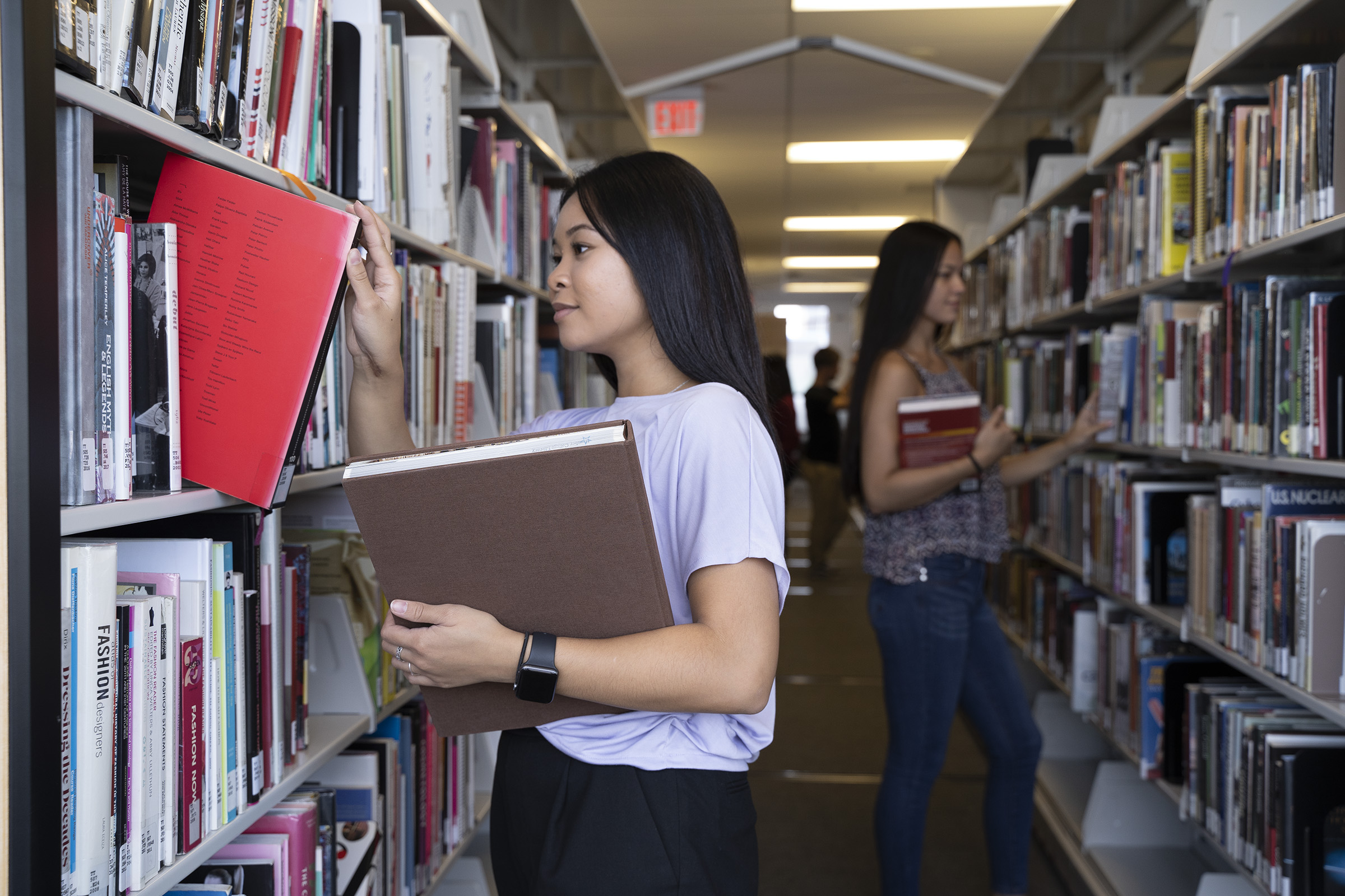 Students looking at books in the library