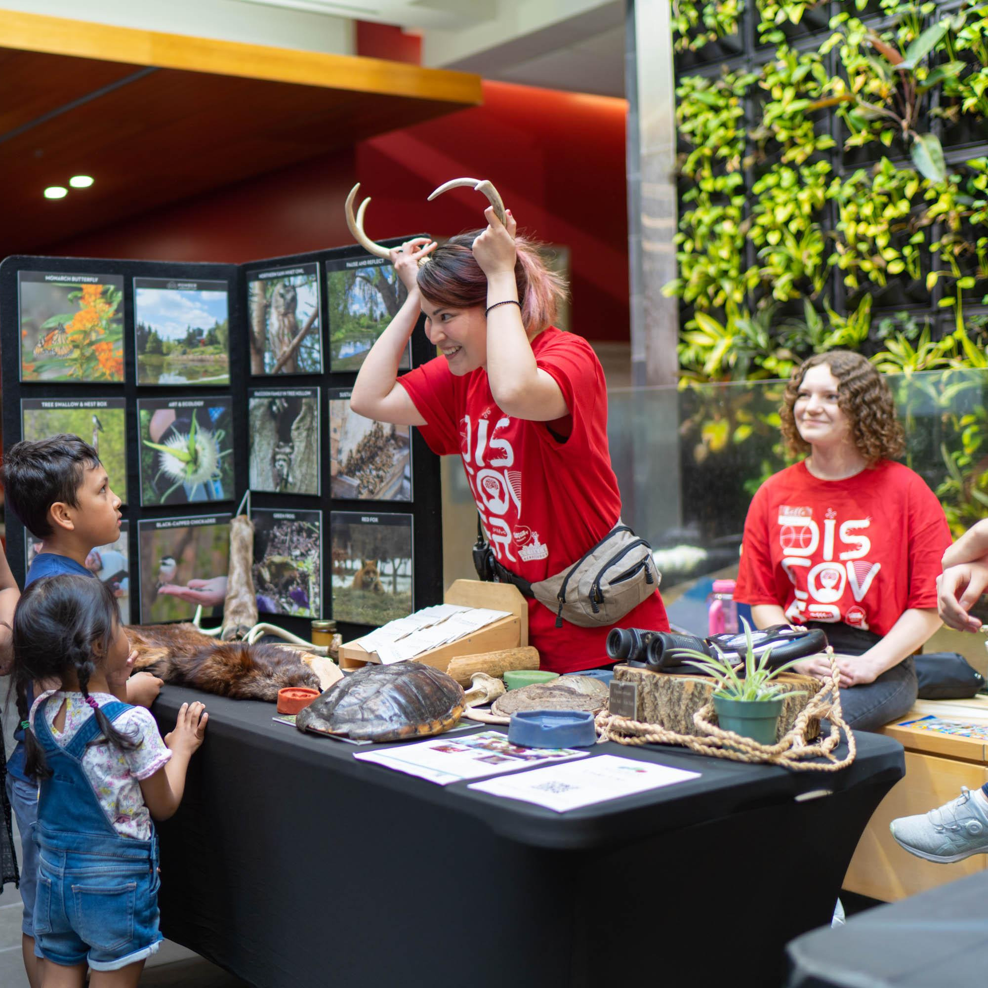 Volunteer showing kids reindeer horns