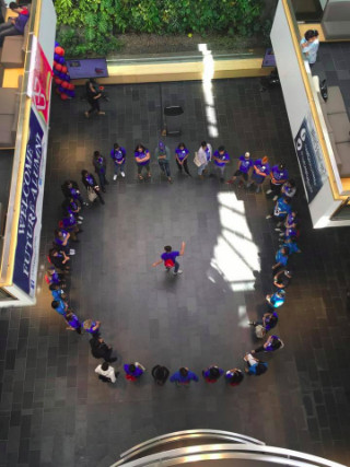 Overhead view of group of students standing in a circle