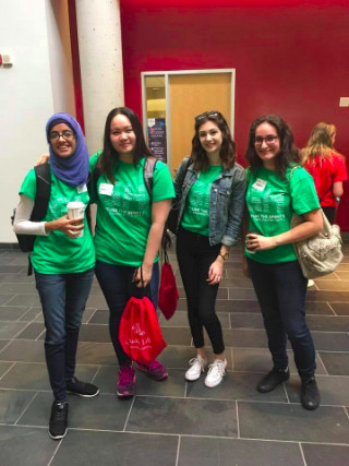 Four students in green orientation shirts
