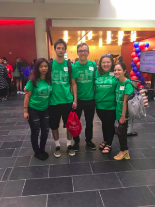 Five students in green orientation shirts