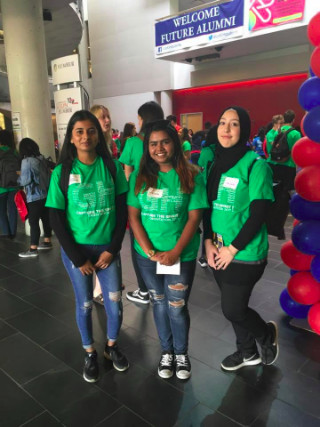 Three students in green orientation shirts