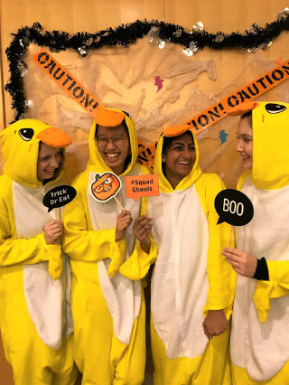 Four students posing in duck costumes