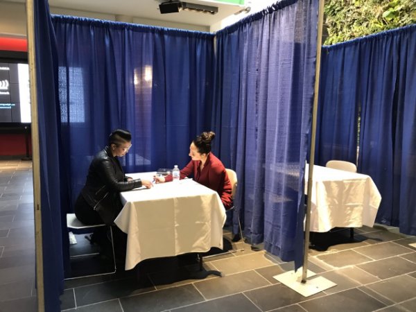 Two people at a table reviewing a resume