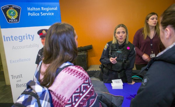 Two students talking to Halton Regional Police officer