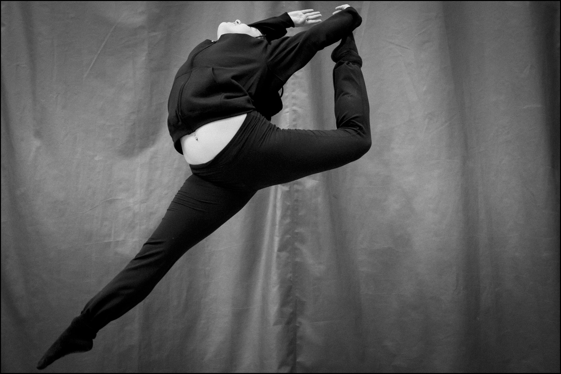 A student leaps in the air during rehearsal