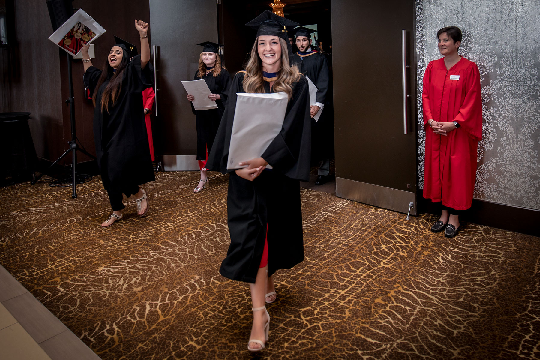 Students celebrate with their degrees and diplomas