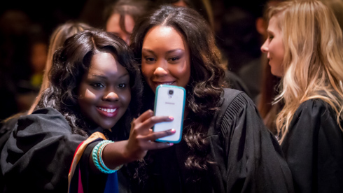 Students taking selfie at convocation 2014