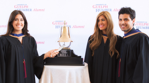 Students ringing bell at convocation 2014