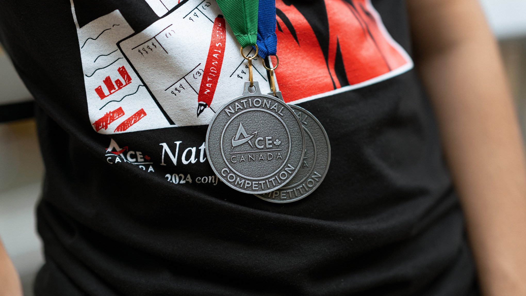 Close up of two medals that say, "ACE Canada National Competition"