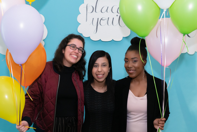Three students pose with balloons