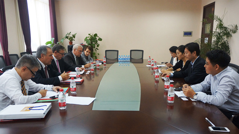 Group photo of staff from East China Normal University (ECNU), University of Guelph (UoG), and University of Guelph-Humber (UofGH) sitting at boardroom table