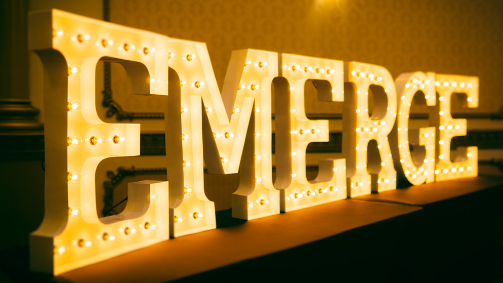 The Emerge logo letters displayed as marquee style letter-lights_