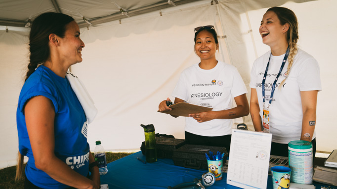 Volunteers discuss health with an athlete