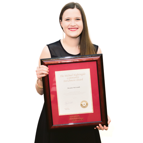 Portrait of Breanne McCoomb holding the Michael Nightingale award.