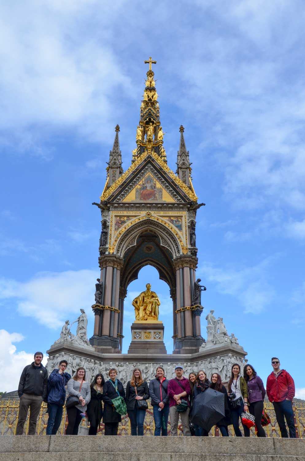 Photo of students posing in front of monument
