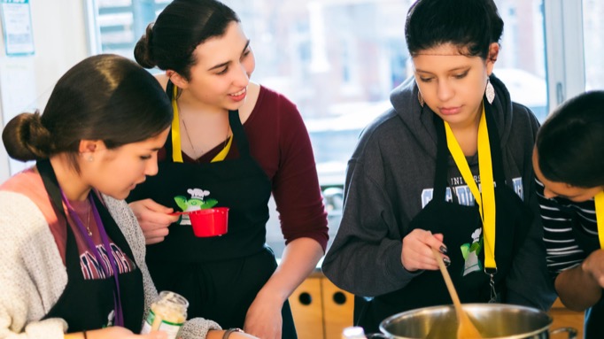 Four students cooking together