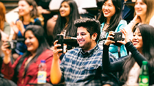 Students taking photos on their smartphones.