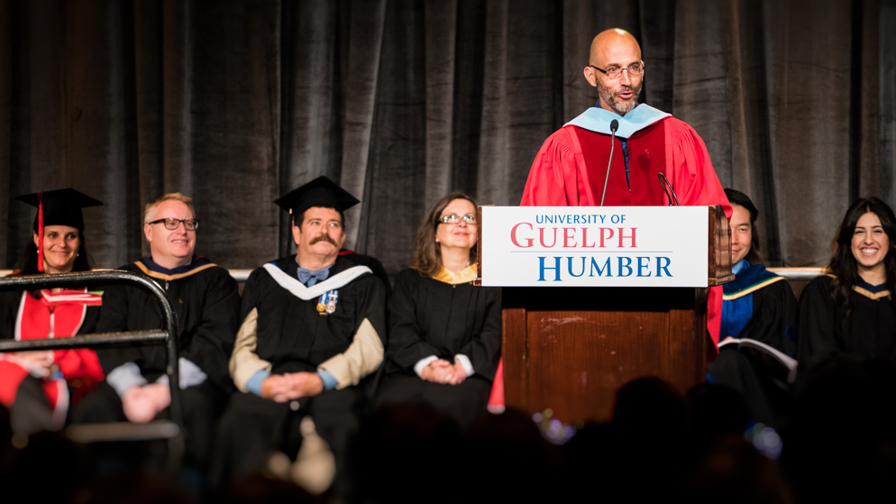 Stephane Grenier speaks to convocation audience from podium