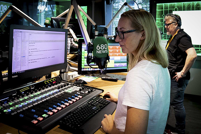 A 680 News staffer working on her computer