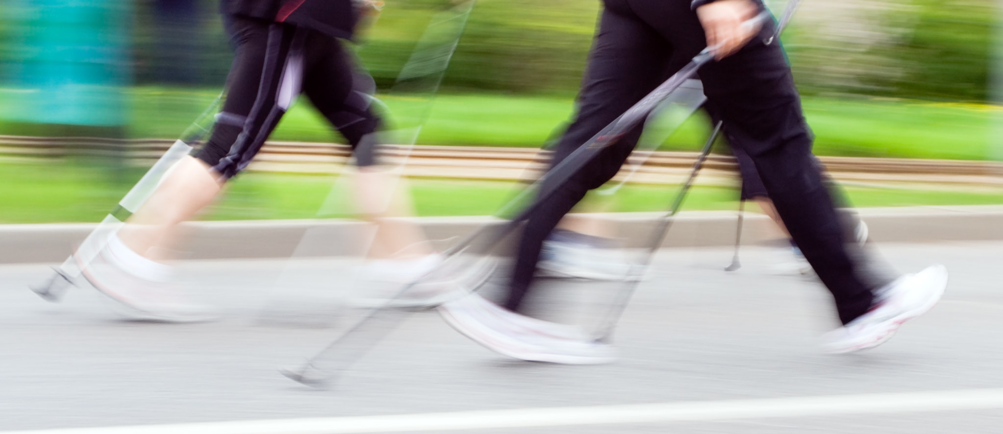 Two people urban poling in motion