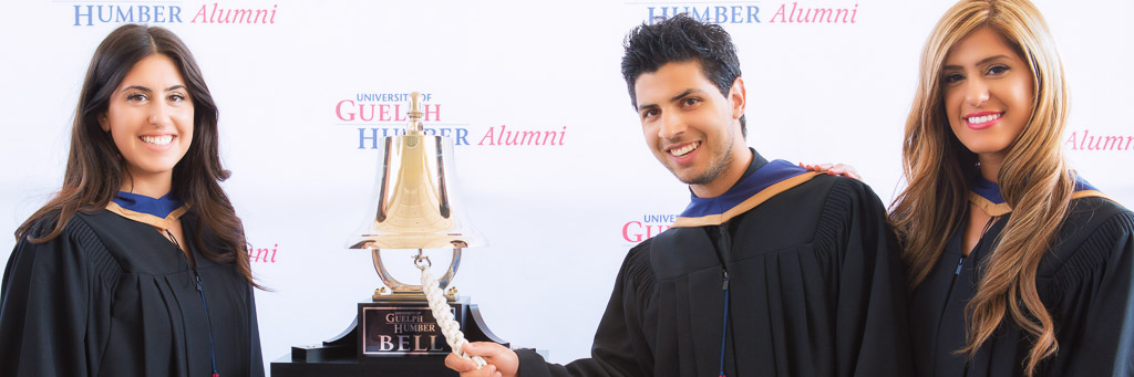 Three University of Guelph-Humber alumni ringing bell.