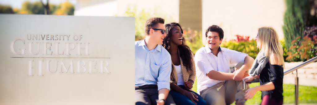 Students hanging out by University of Guelph-Humber sign.