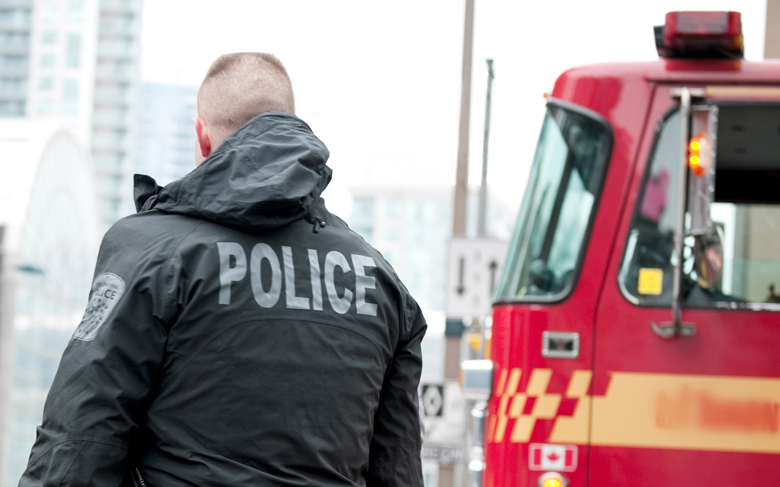 police officer in front of fire truck