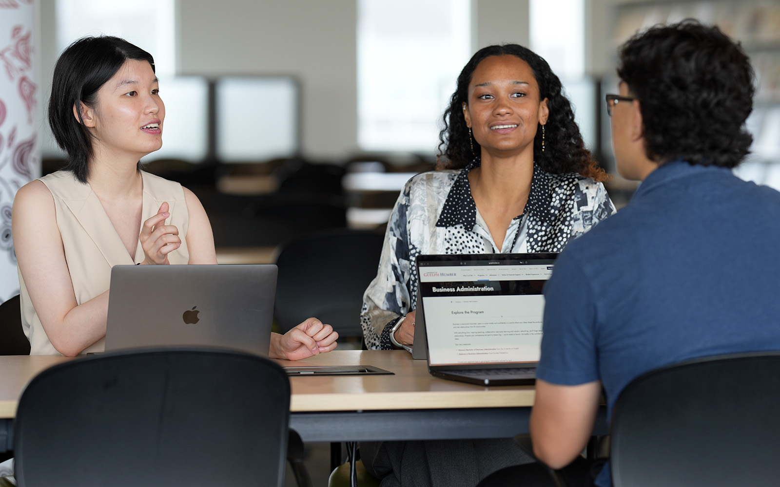 three students having a discussion
