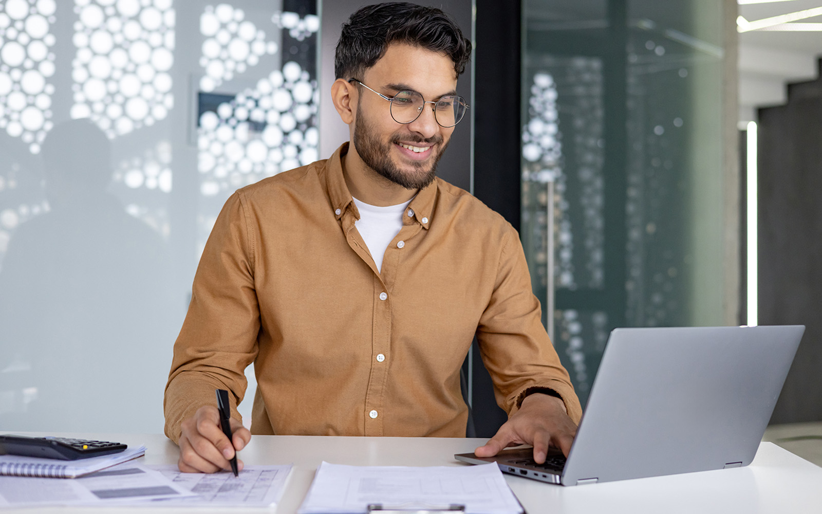 man with laptop and papers