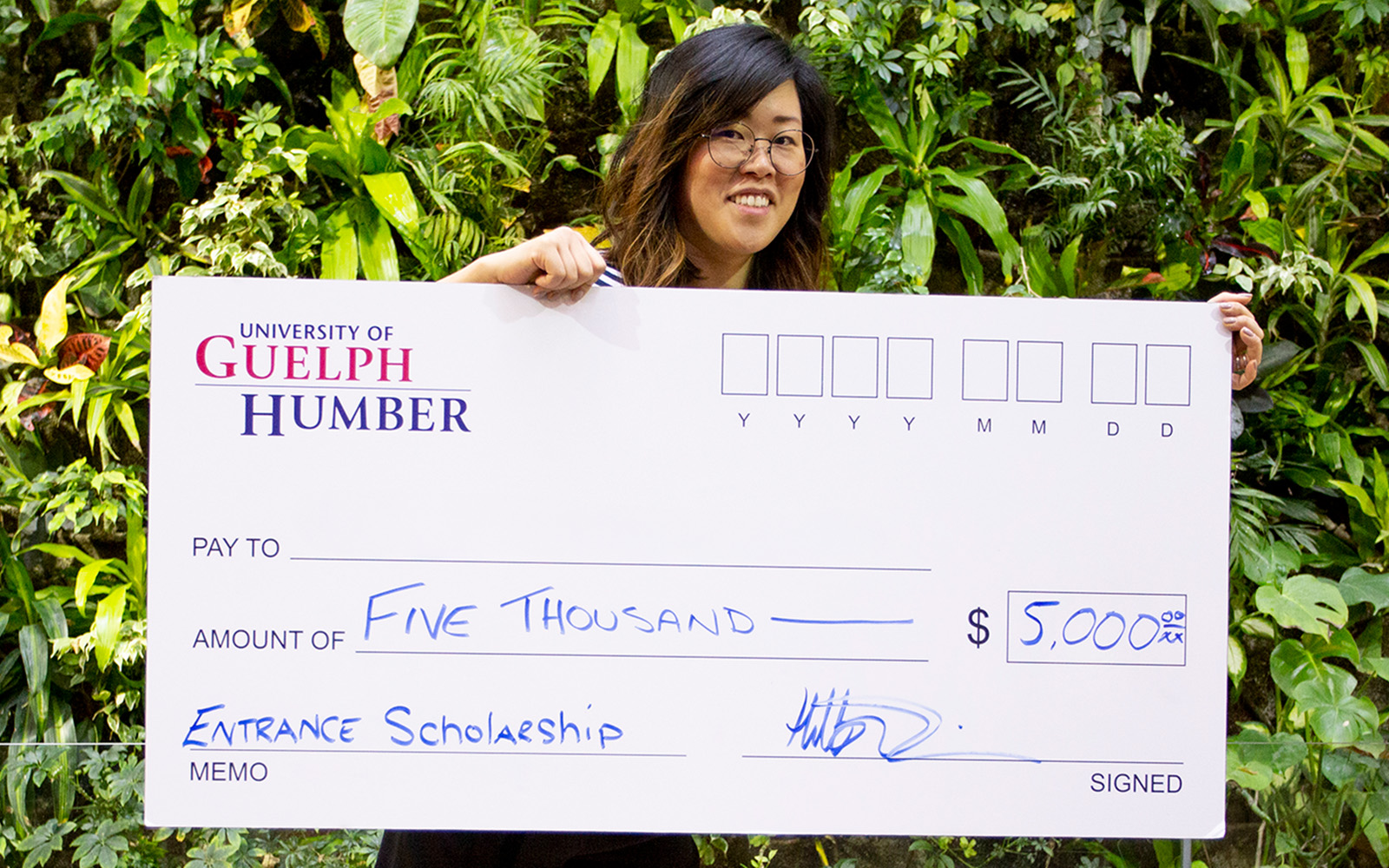 woman holding a giant cheque