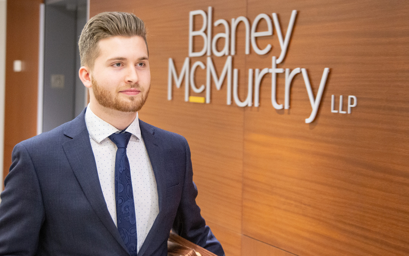 student holding files at law firm