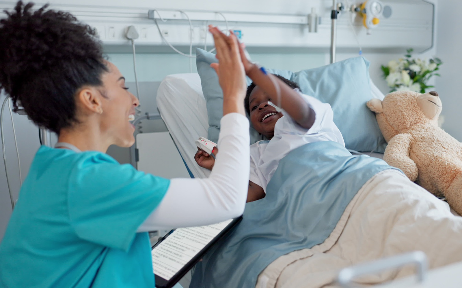 woman giving child in hospital a high-5