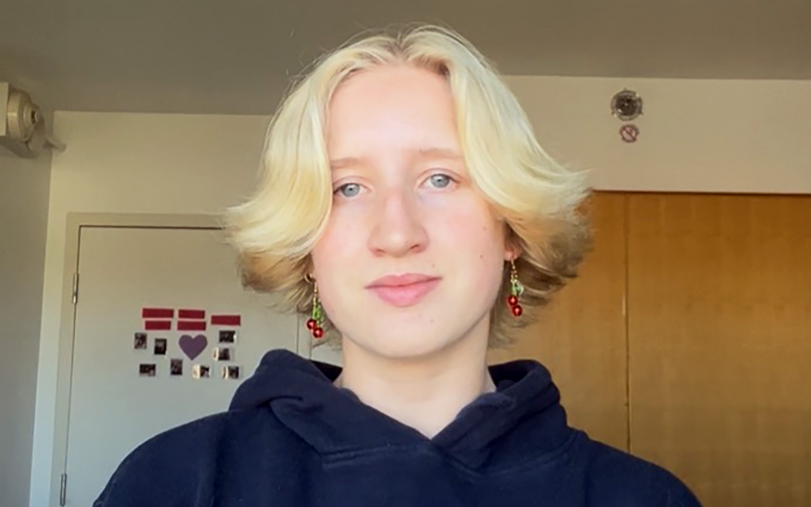 student with blonde hair with earrings