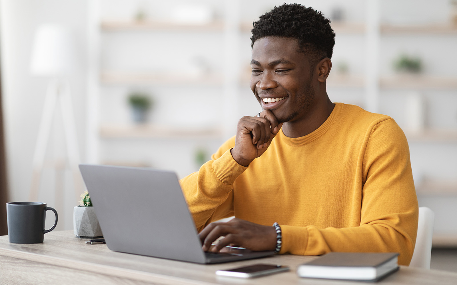 student at desk with laptop