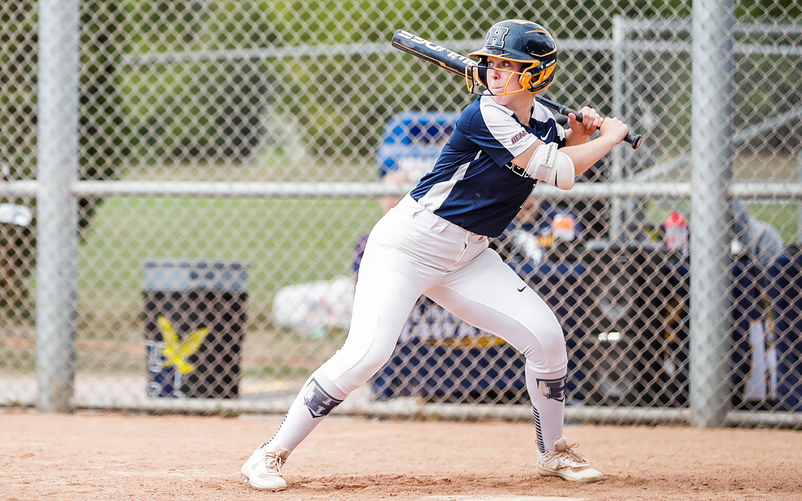 student with a softball bat