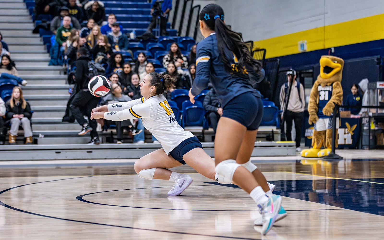 athlete diving for a volleyball