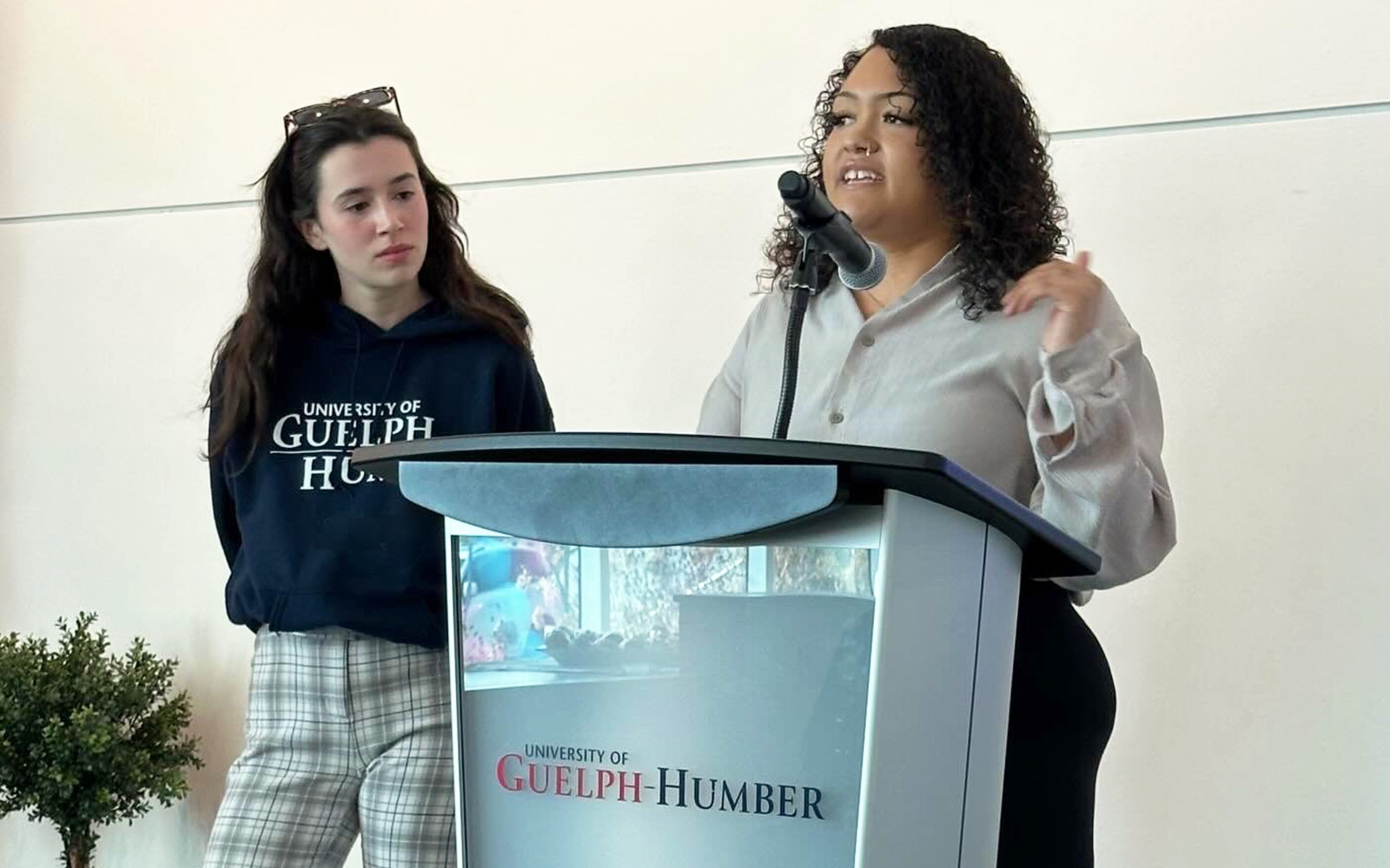 two students at a podium