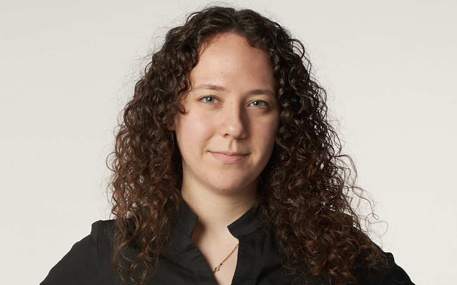 student with curly dark hair