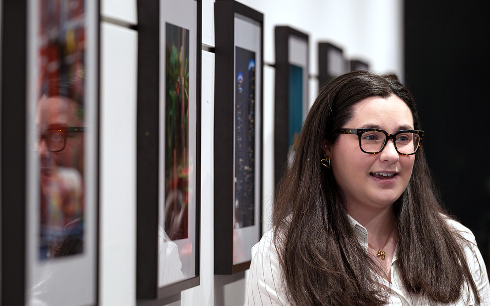 student standing in front of photography