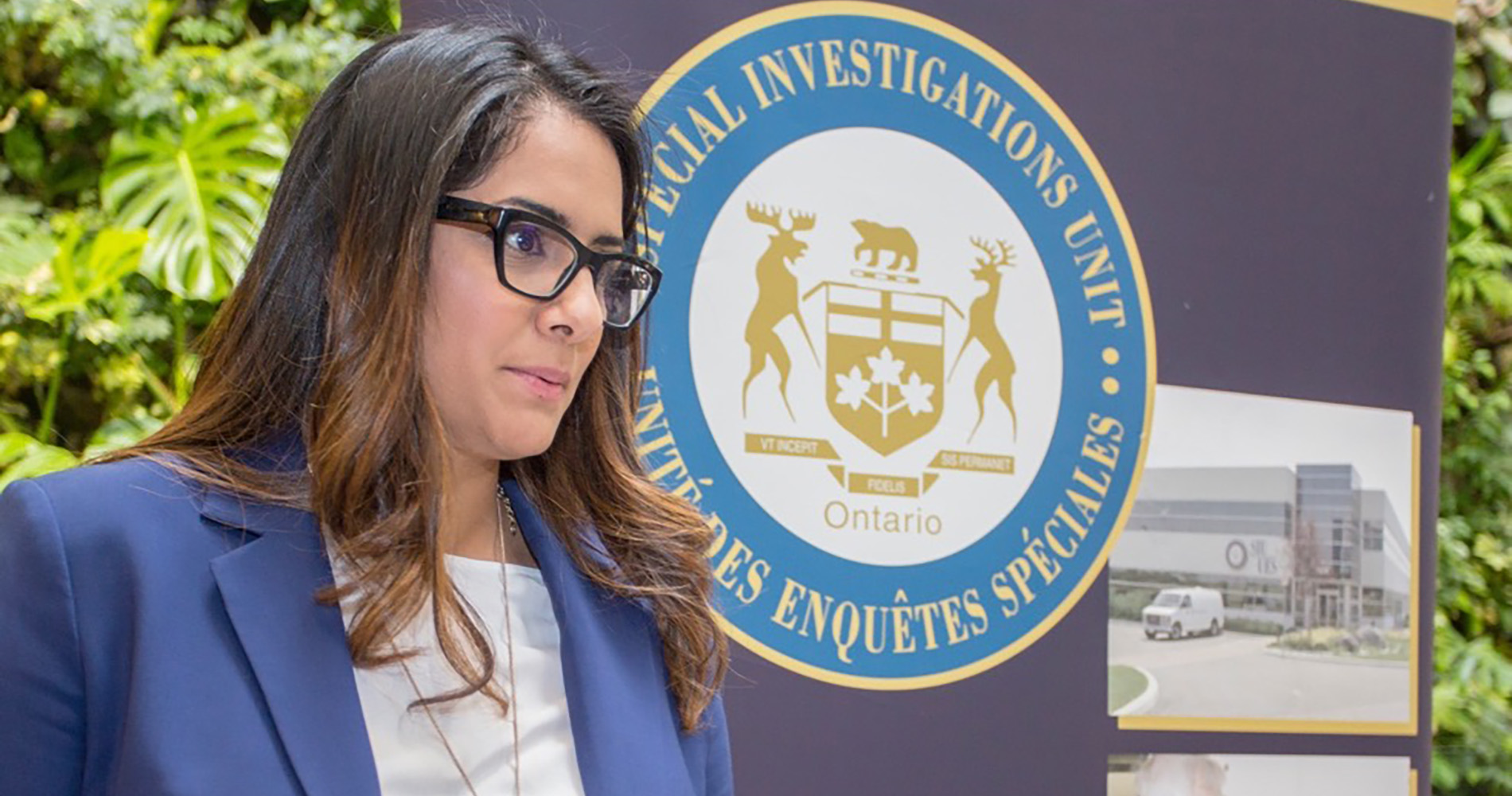 woman in front of special investigations banner