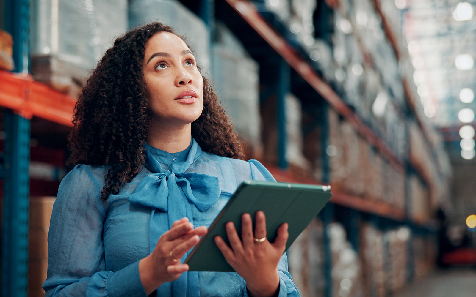 woman holding tablet in a warehouse