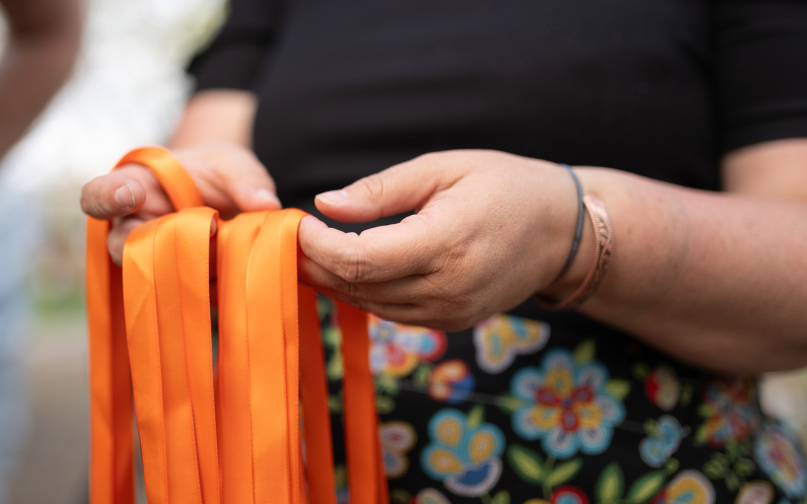 person holding orange ribbons