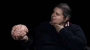 Christopher Schiafone holds a model of the brain