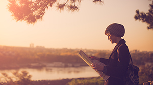 A tourist reading a newspaper