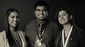 Three students wearing medals