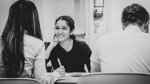 Three UofGH students work on a presentation