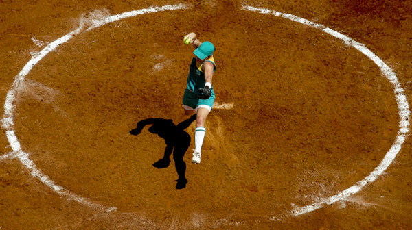 A softball pitcher throws the ball